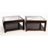 A pair of ebonised coffee tables with inset glass tops,
