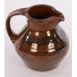 Possibly Stoneshill Pottery, a glazed stoneware jug, SP mark,