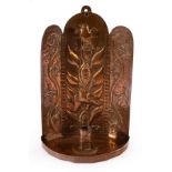 John Pearson (1859-1930), an Arts & Crafts copper wall sconce, embossed birds in foliage,