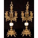 A pair of four-branch brass candelabra, the stems with white marble knops,