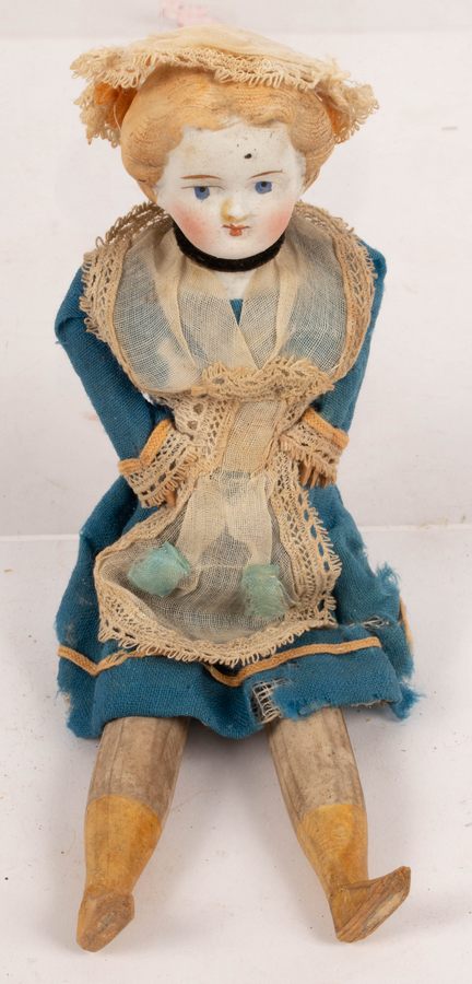 A bisque head doll with wooden legs and arms,