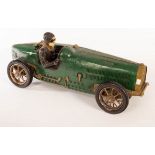 A fibreglass model of a 1930s Bugatti racing car and driver, painted green,