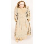 An early bisque head doll with fixed eyes and chamois body,