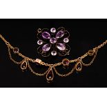 An amethyst fringe necklace on yellow metal chain,