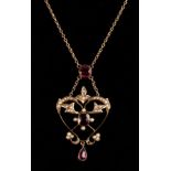 An Edwardian garnet and pearl heart-shaped pendant necklace, centred by a garnet of cushion shape,