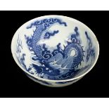 A 19th Century Chinese blue and white bowl, the whole decorated dragons within clouds,