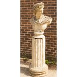 A composition stone bust of Apollo on a fluted plinth,