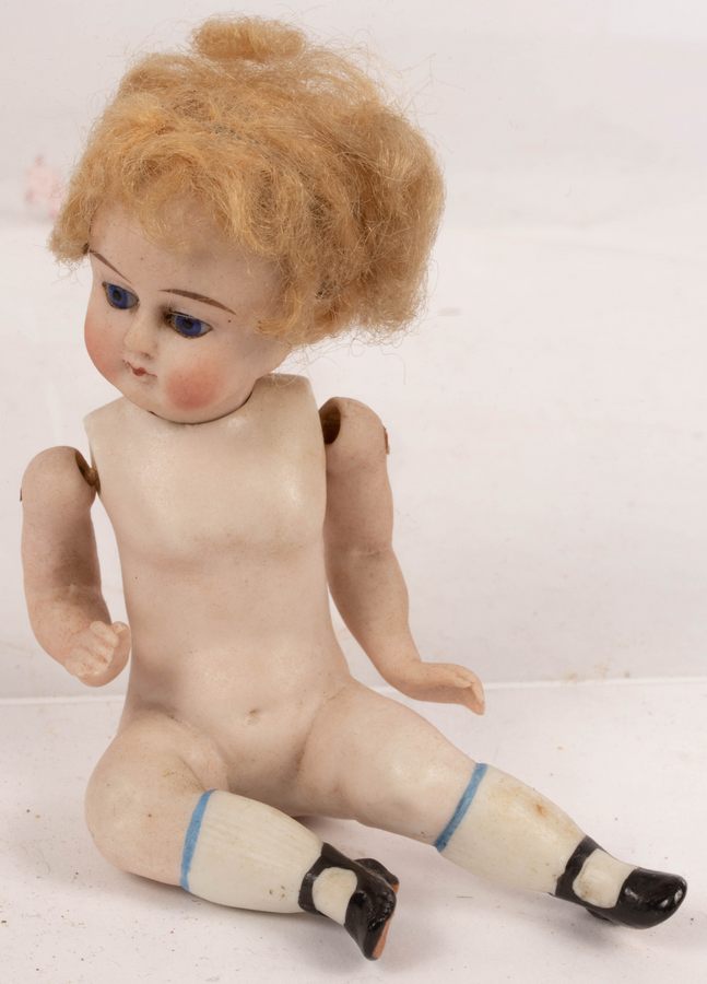 A French bisque doll with jointed arms,