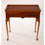 A reproduction silver table, fitted a single drawer on cabriole legs,