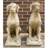 A pair of composition stone figures of seated dogs,