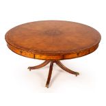 A large circular dining table by Jonathan Charles,