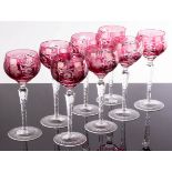 A set of eight wine glasses, the ruby coloured bowls with cut decoration,