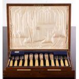 A set of twelve silver fish knives and forks, with ivory handles, Goldsmiths & Silversmiths Co Ltd.