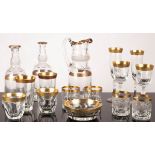 A large quantity of Moser style glassware, with tooled gilt rims,