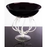 An Art Glass tazza, the circular amethyst coloured class bowl on trailed white supports, 29.