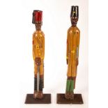 Two wooden carved and painted military figures, one a soldier of the Kings African Rifles,