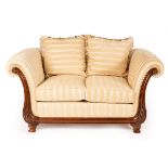 A Victoria furniture two-seat sofa, with carved scroll ends on turned feet,