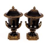 A pair of gilt metal mounted campana shaped urns and covers,