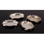 A set of four silver ashtrays, John Collard Vickery, Chester 1926, of shaped oval form, 8.