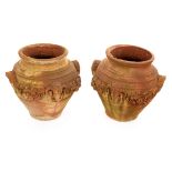 A pair of terracotta finish garden urns,