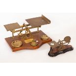 A set of late 19th Century parcel scales on an oak base and a small set of postal sales