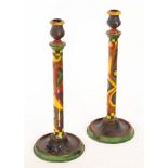 A pair of painted and decorated turned wood candlesticks on circular bases, 39.