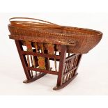 A Chinese basket crib on a carved, painted and decorated stand,