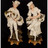 A pair of French bisque and glazed porcelain figures of a gentleman and lady grape pickers,