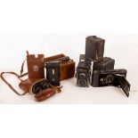 A pair of Lemaire field glasses in a leather case, a Rexoflex camera in a case,