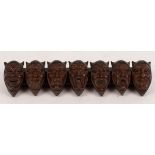 A pipe rack, the supports in the form of jester mask heads,