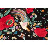 A Chinese black silk shawl with fringed border, embroidered flowers and birds in colour,