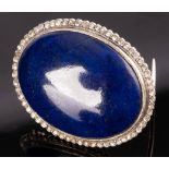 A lapis lazuli and diamond brooch, the oval lapis cabochon to a surround of rose cut diamonds, 3.