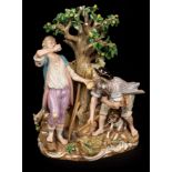 A large Meissen figure group of three farmers about a pear tree, with hound and sheep,