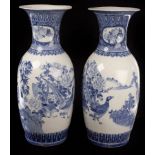A pair of blue and white Japanese baluster vases with flanged tops,