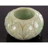 A Chinese celadon jade water vessel, 20th Century, carved lotus flowers around the body,