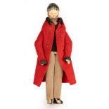 An 18th Century German wooden doll with a red coat, 16.