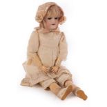 A German bisque head doll by Handwerg with composition body,
