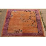 A Chinese Art Deco style carpet, the purple and orange ground decorated flowers etc.