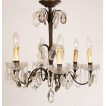 A pair of cut glass three-light chandeliers with spiral branches hung trails of prismatic drops and