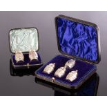 A cased pair of silver pepper pots, EH, London 1913 and a cased set of four similar pepper pots,