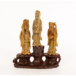 A Chinese carved soapstone group of three deities, 20th Century,