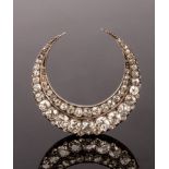 A Victorian diamond crescent brooch, set with two rows of graduated cushion-shaped stones,