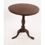 A 19th Century oak table on a turned column and tripod support,