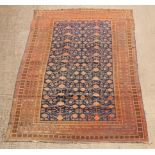 A Hamadan rug, the all over geometric design on a blue ground, within a multi figured border,