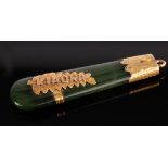 An Edwardian 15ct gold and nephrite pear-shaped Kia Ora pendant, sponsors mark HB, 5cm long,