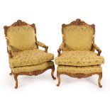 A pair of Louis XIV style gilt framed armchairs, with shell decoration to the crest rail,