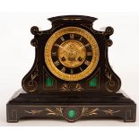 A late 19th Century black slate mantel clock, fitted an eight-day movement striking on a gong,