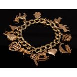 An Italian 14k yellow gold charm bracelet hung with a variety of 14k and unmarked yellow metal