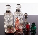 A pair of cut glass scent bottles with silver mounts, 16.