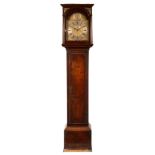 An 18th Century walnut longcase clock, circa 1720, the hood with brass spandrels and plain columns,